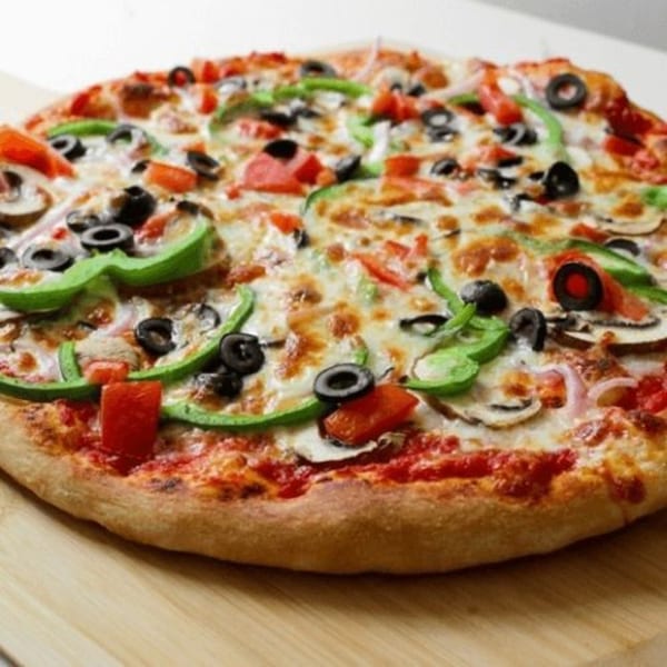 A whole Li'l Nick's Pizza with green peppers, black olives, mushrooms, and tomatoes.